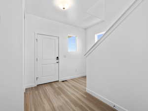 Foyer entrance featuring light hardwood / wood-style floors