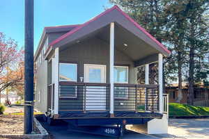 View of property exterior featuring covered porch