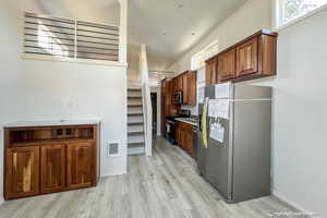 Kitchen featuring appliances with stainless steel finishes and light hardwood / wood-style flooring