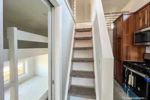 Staircase with hardwood / wood-style floors