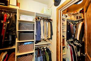 Fully equipped walk-in master closet with additional owner's lock-out closet