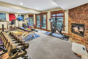 Fabulous work-out room with fireplace and space for a sauna. French doors open to a covered porch with seasonal brook