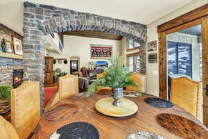 Dining area featuring a stone fireplace