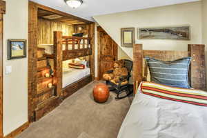 Ensuite bunk room with rustic, hand hewn, wood-framed sleeping areas that sleeps 4 (upper level)