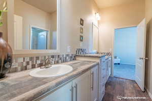 Bathroom with vanity and backsplash