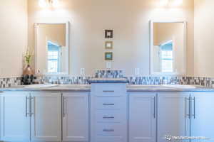 Bathroom with backsplash and vanity