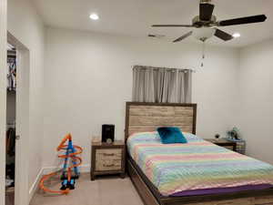 Master bedroom featuring light colored carpet and ceiling fan