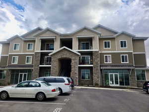 View of building exterior from parking stall, north side.