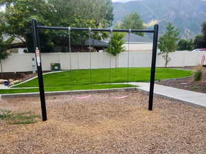 View of play area featuring a lawn and a mountain view