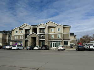 View of building exterior from street parking, south side.