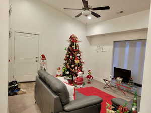 Carpeted living room with ceiling fan