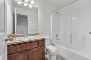 Full bathroom featuring ceiling fan, shower / bathing tub combination, toilet, and vanity