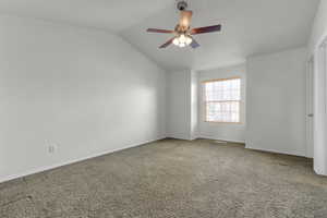 Main bedroom with ceiling fan and lofted ceiling