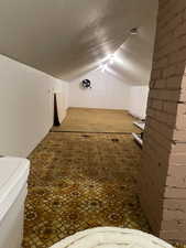 Bonus room featuring carpet and vaulted ceiling