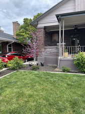 View of front of house featuring covered porch and a front lawn