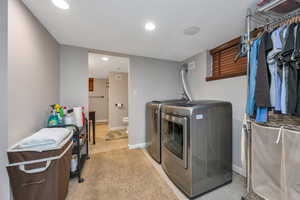 Washroom with washer and clothes dryer