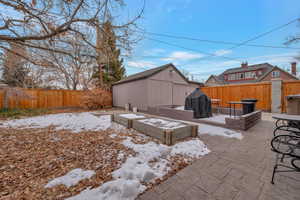 Patio featuring a storage unit and area for grilling