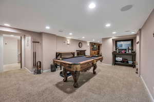 Game room with billiards and light carpet