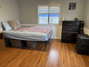 Bedroom with light hardwood / wood-style flooring