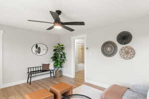 Living area featuring light hardwood / wood-style floors and ceiling fan