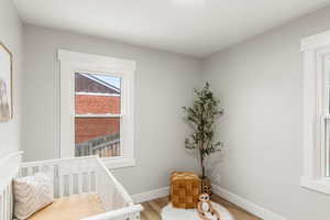 Bedroom 2 with LVP Flooring and a nursery area