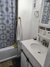 Bathroom with tile patterned flooring, vanity, and shower / bathtub combination with curtain