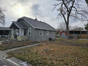 View of property exterior with a storage unit