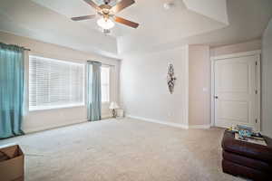 Interior space featuring ceiling fan and a raised ceiling