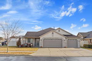 View of front of property featuring a garage and a front yard