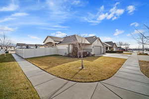 View of front of house with a front yard and a garage