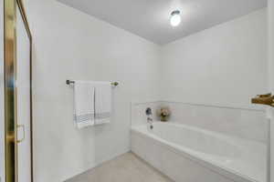 Bathroom featuring a bathtub and a textured ceiling