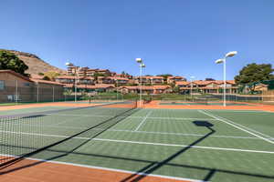 View of tennis court featuring basketball court