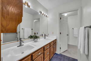 Bathroom featuring tile patterned flooring, vanity, and a textured ceiling