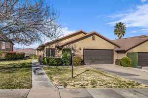 Ranch-style home with a garage and a front yard