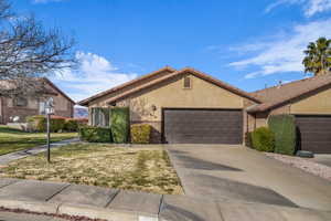 Single story home featuring a front lawn