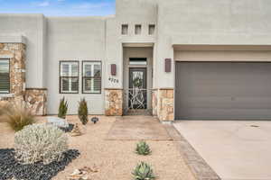 Doorway to property featuring a garage