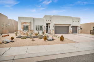 Pueblo-style home with a garage