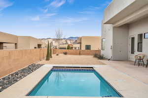 View of swimming pool featuring a patio area and a mountain view