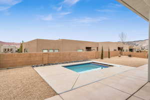 View of pool with a patio area and a mountain view