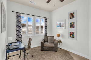 Office area with ceiling fan and hardwood / wood-style flooring