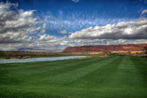 View of community featuring a water and mountain view and a yard