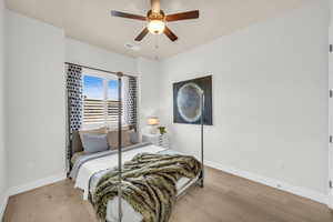 Bedroom with ceiling fan and light hardwood / wood-style floors