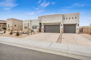 Pueblo-style house with a garage