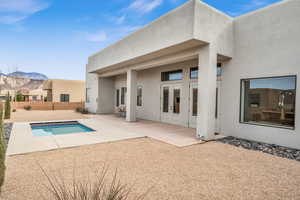 View of swimming pool with a mountain view and a patio