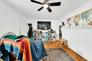 Living room featuring hardwood / wood-style floors and ceiling fan