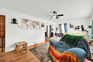 Living room with hardwood / wood-style flooring and ceiling fan