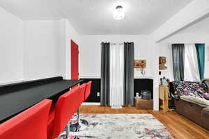 Interior space featuring hardwood / wood-style floors and a textured ceiling