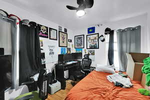 Bedroom with hardwood / wood-style flooring