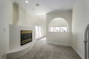 Living room with light carpet and crown molding