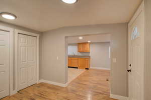 Entryway featuring light wood-type flooring and sink